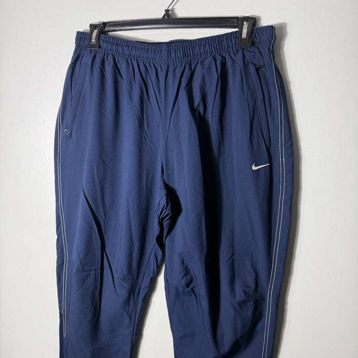 NIKE DRI FIT PARACHUTE TROUSER WITH SIDE ZIP POCKETS BLUE COLOUR