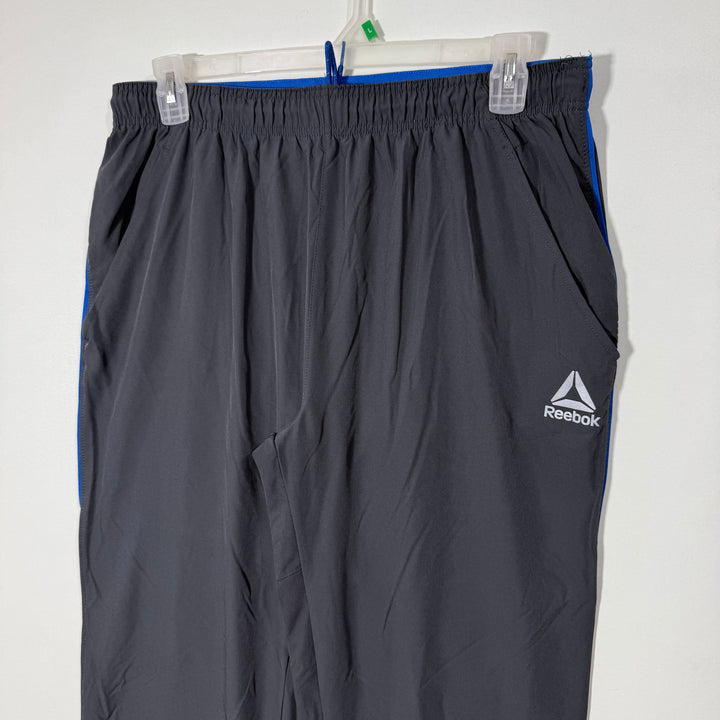 REEBOK LOOSE FIT HYBRID PARACHUTE TROUSER GREY COLOUR