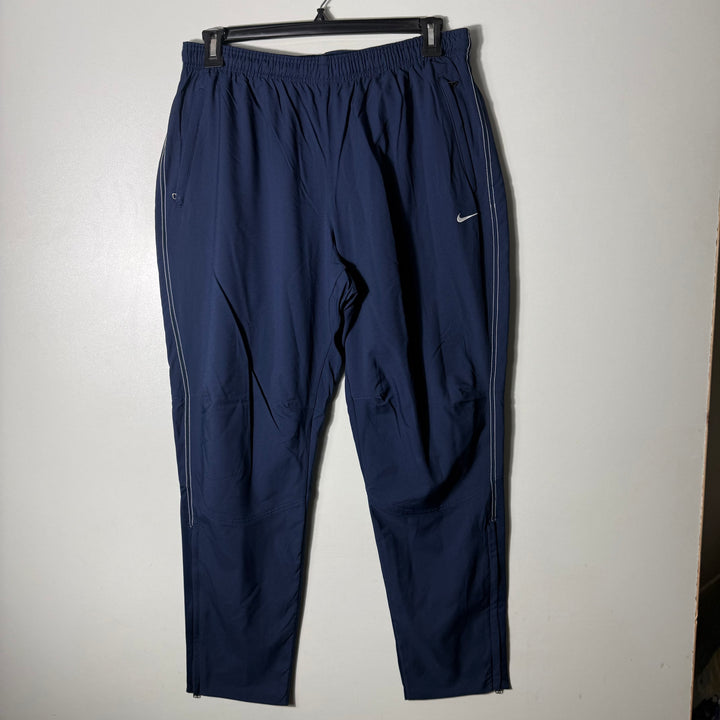 NIKE DRI FIT PARACHUTE TROUSER WITH SIDE ZIP POCKETS BLUE COLOUR